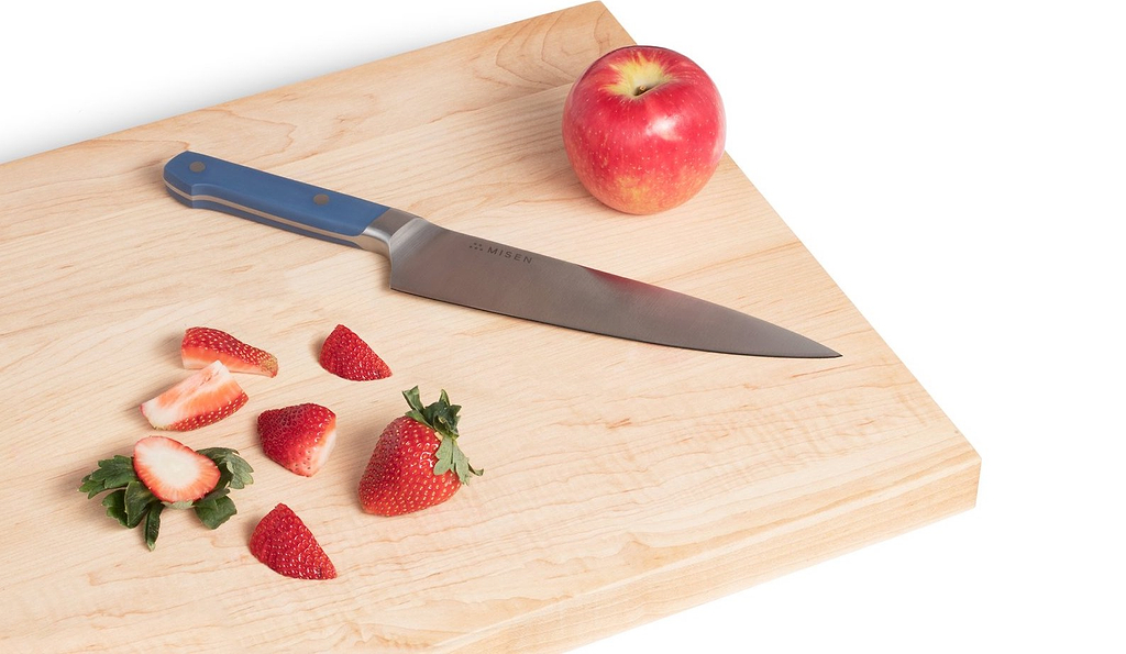 Best chef's knives: the Misen chef's knife on a cutting board with fruit