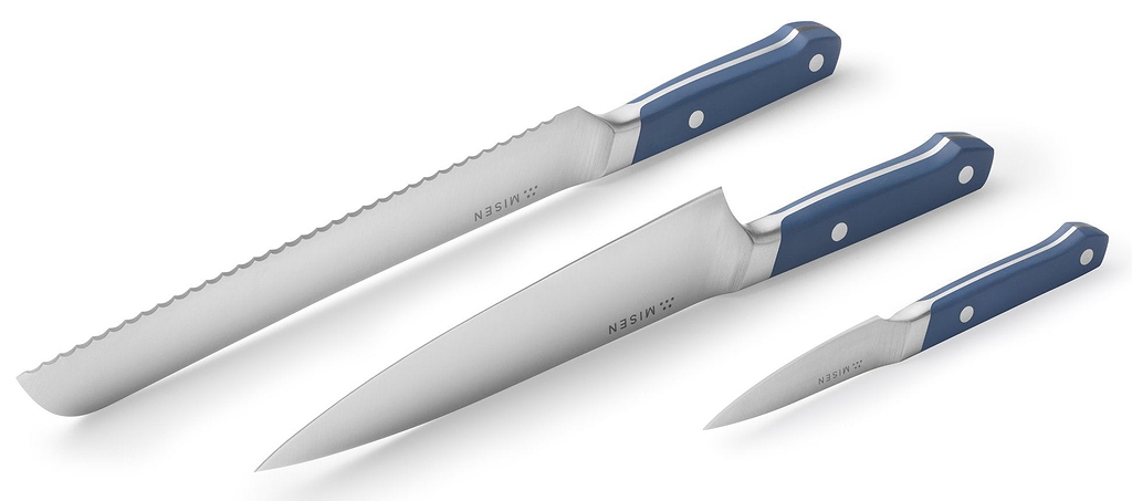 Knife handle material: a row of Misen knives with their blades and handles facing up