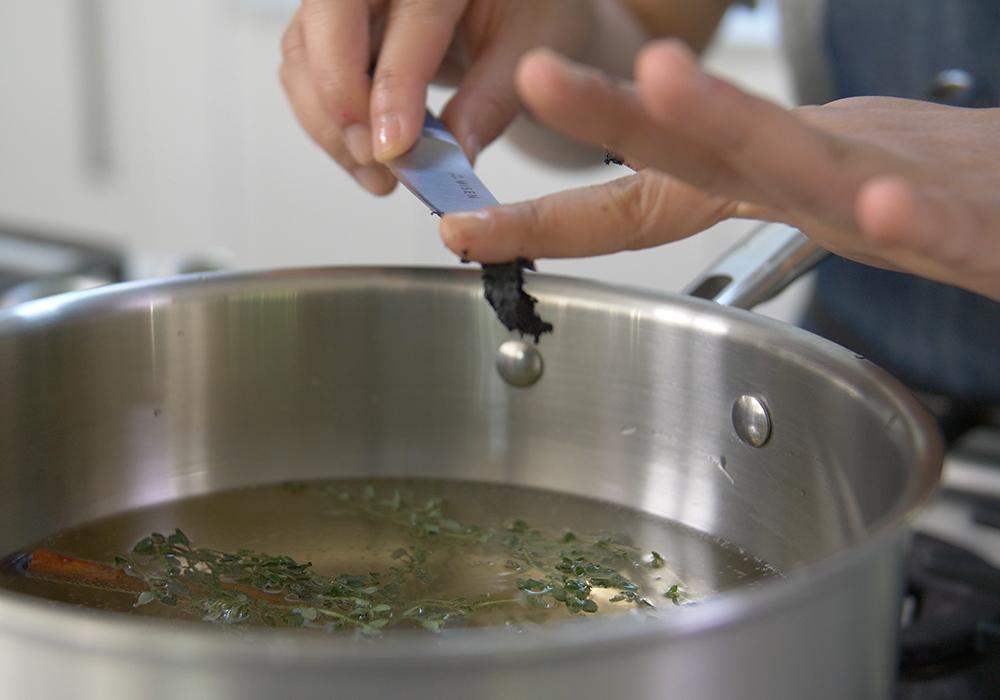 How to clean a burnt pan: A chef scrapes ingredients into a pot