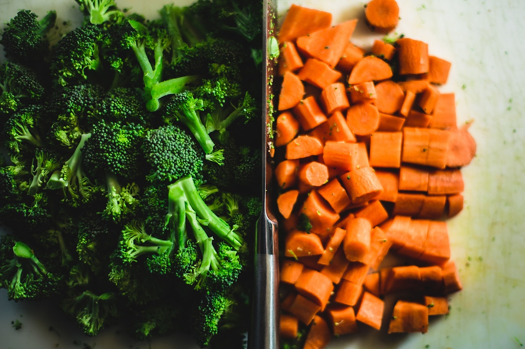 Knife sharpening: A knife separates a pile of broccoli from a pile of carrots