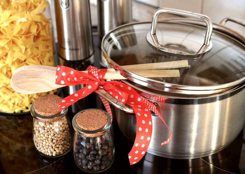 Cooking with stainless steel: a stainless steel stock pot and wooden utensils with a bow