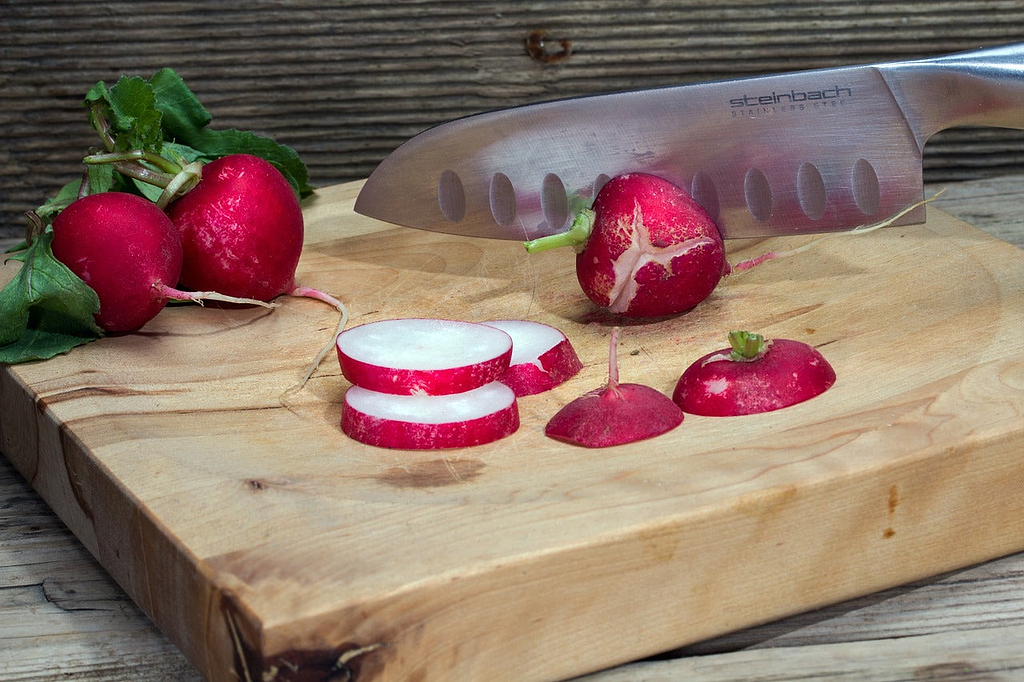 Chefs knives: A knife chops radishes