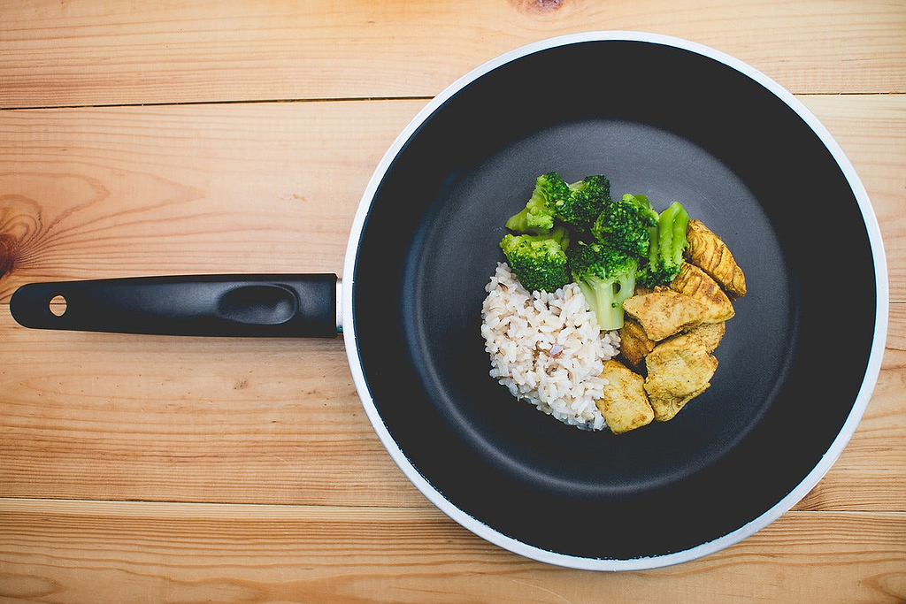 Types of pans: a nonstick skillet with rice, broccoli, and chicken inside