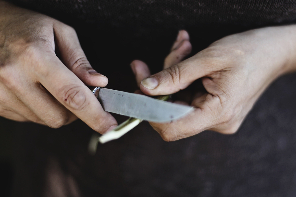 How to sharpen a knife: A man sharpens a knife