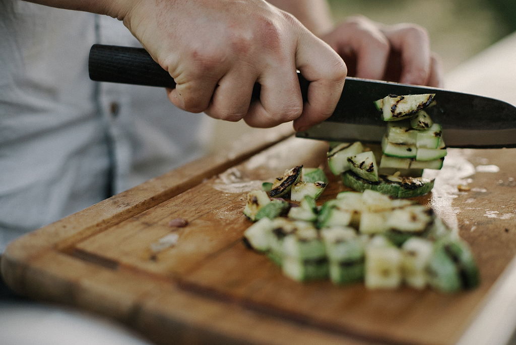 What is a santoku knife: a chef chopping vegetables