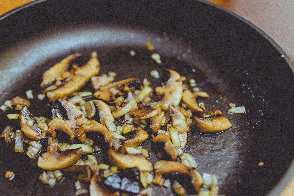 Ceramic vs. Teflon: Closeup on mushrooms in a Teflon pan