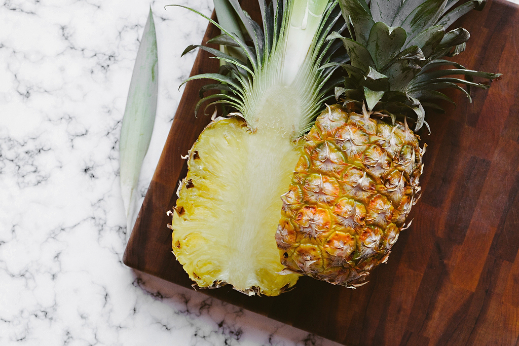 Best wood for cutting board: a pineapple on a dark wood cutting board