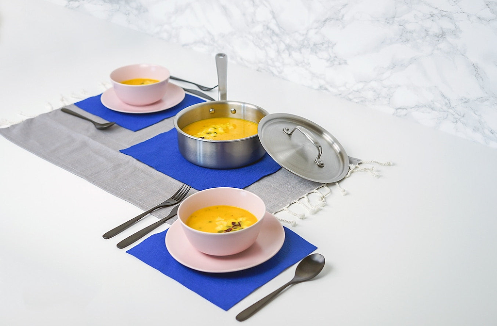 Types of pans: a stainless steel saucier and two bowls of soup