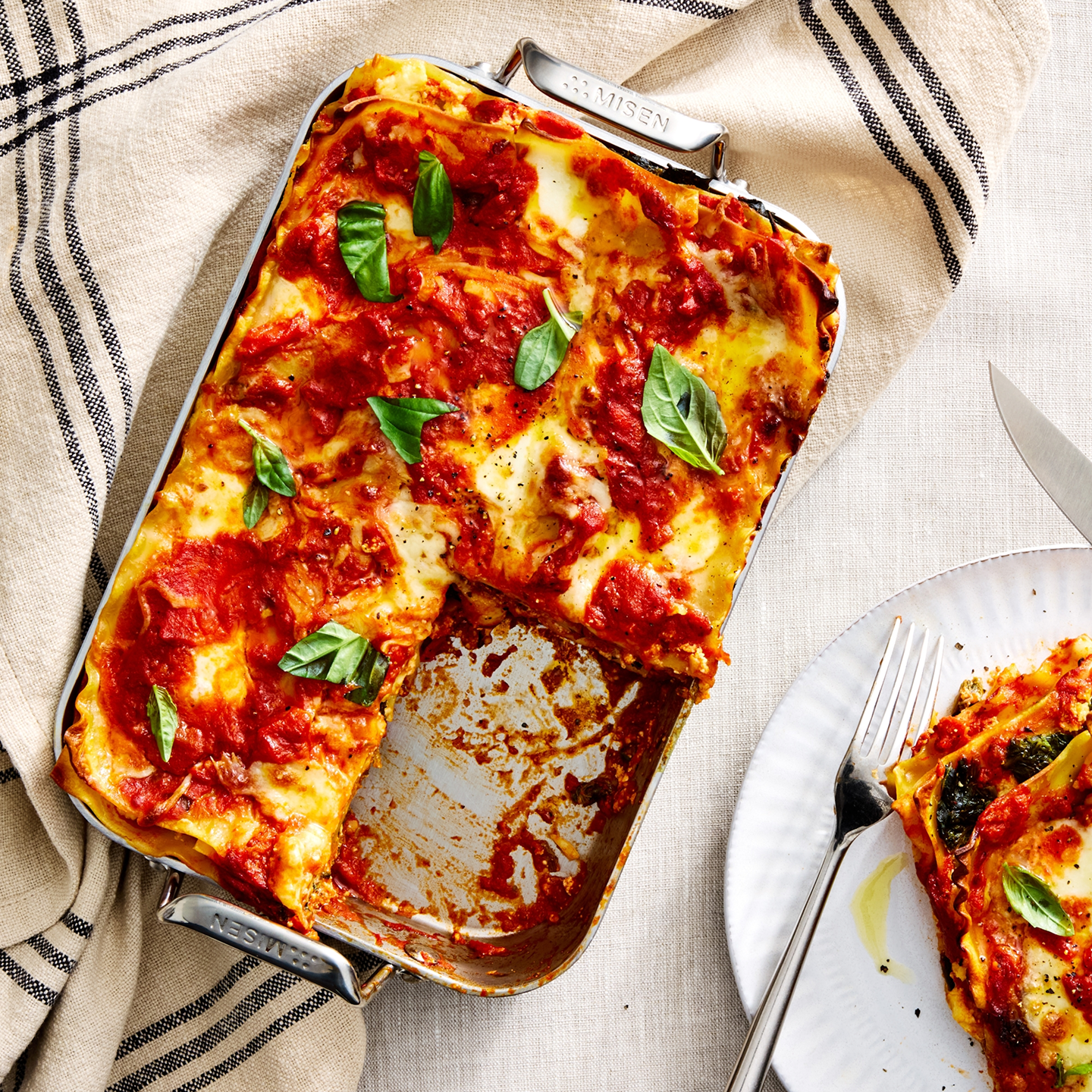 Homemade vegetable lasagna in Misen stainless steel baking pan with fresh basil