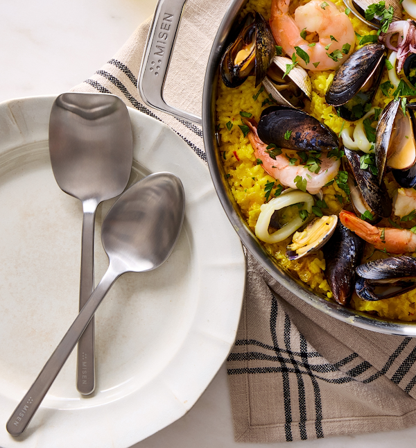 Misen pan with seafood paella featuring mussels, shrimp, and squid served with Misen spoons