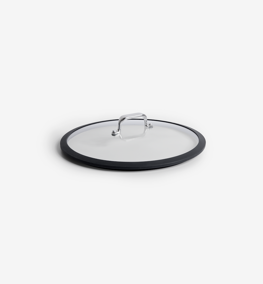 Glass pan lid with black silicone rim and stainless steel handle