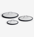Set of three glass pan lids with silicone rims and stainless steel handles in small, medium, and large sizes