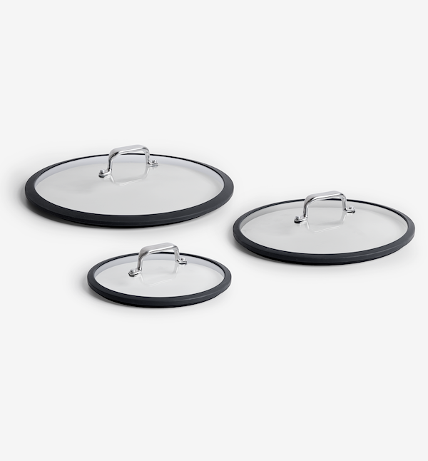 Set of three glass pan lids with silicone rims and stainless steel handles in small, medium, and large sizes