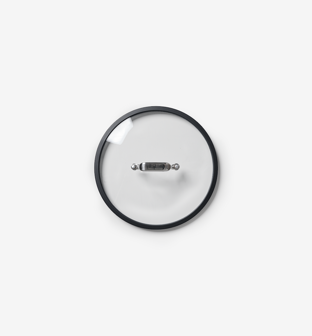 Glass cookware lid with stainless steel handle and black silicone rim, top view