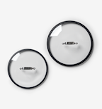 Two glass pot lids with black rim and stainless steel handles, top-down view