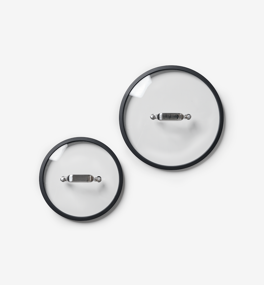 Glass cookware lids with black rim and stainless steel handle, set of two sizes