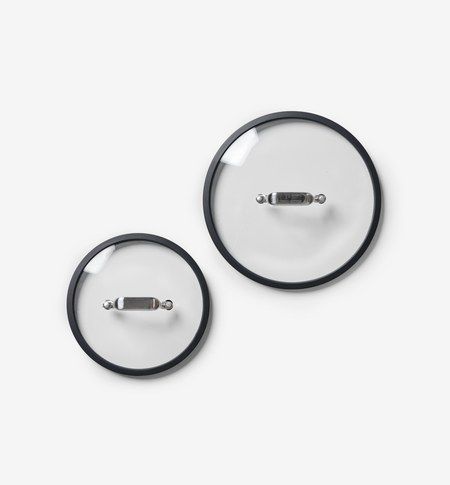 Glass cookware lids with black rim and stainless steel handle, set of two sizes