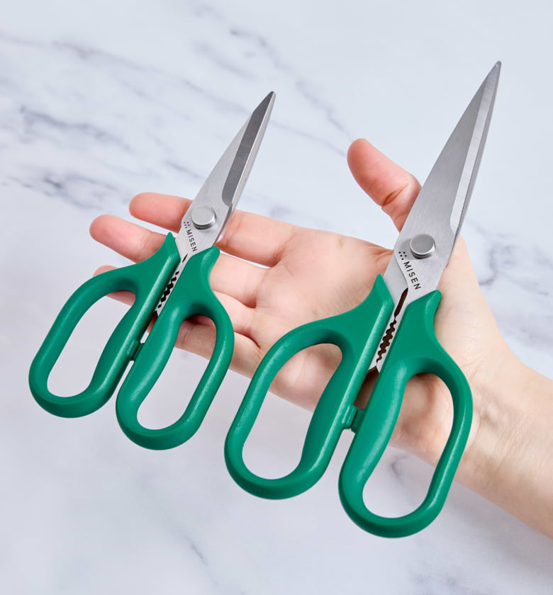 Misen kitchen shears with green handles held in hand, set of two