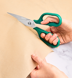Misen kitchen scissors cutting kraft paper with teal handles
