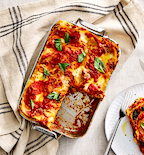Homemade lasagna in Misen baking pan with tomato sauce and fresh basil