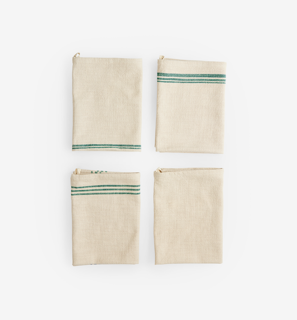 Set of 4 natural linen kitchen towels with green stripe detail, folded flat lay