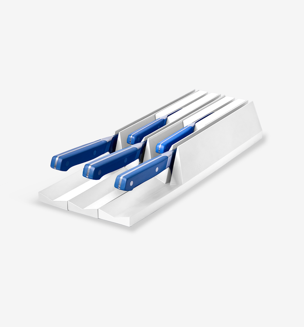 Kitchen knife drawer organizer with blue-handled knives in white slots