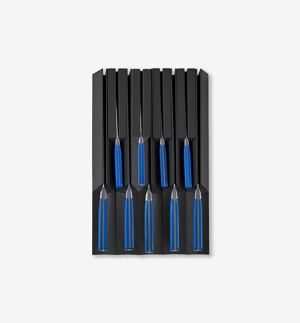 Set of steak knives with blue handles stored in black knife block organizer