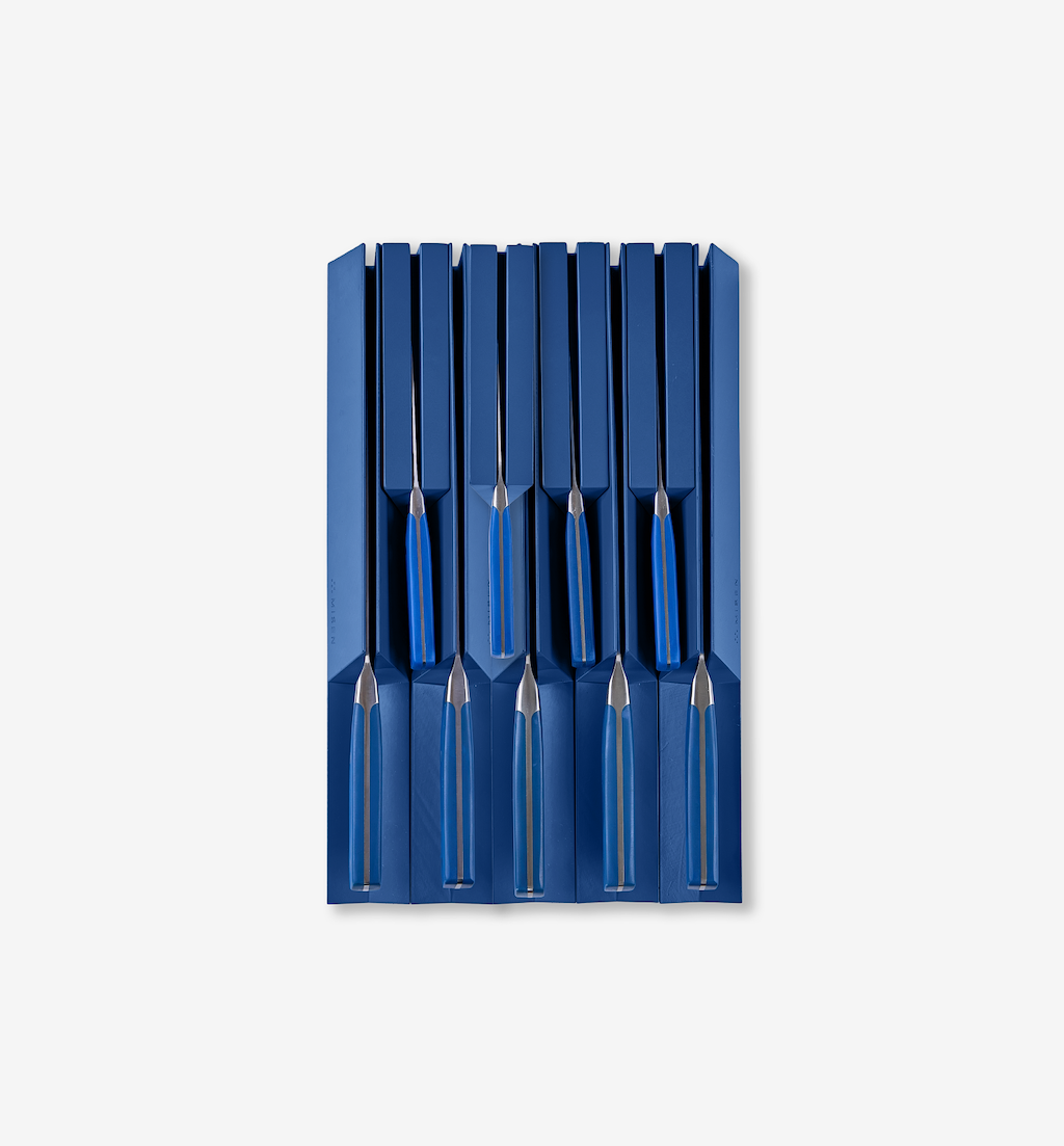 Blue knife block set with stainless steel knives and blue handles organized in slots