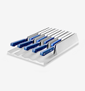 Kitchen knife set with blue handles stored in white drawer organizer block
