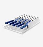 Kitchen knife set with blue handles stored in white drawer organizer block