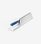 Kitchen knife with blue handle resting in white countertop knife storage dock