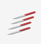 Set of 4 steak knives with red handles and serrated stainless steel blades