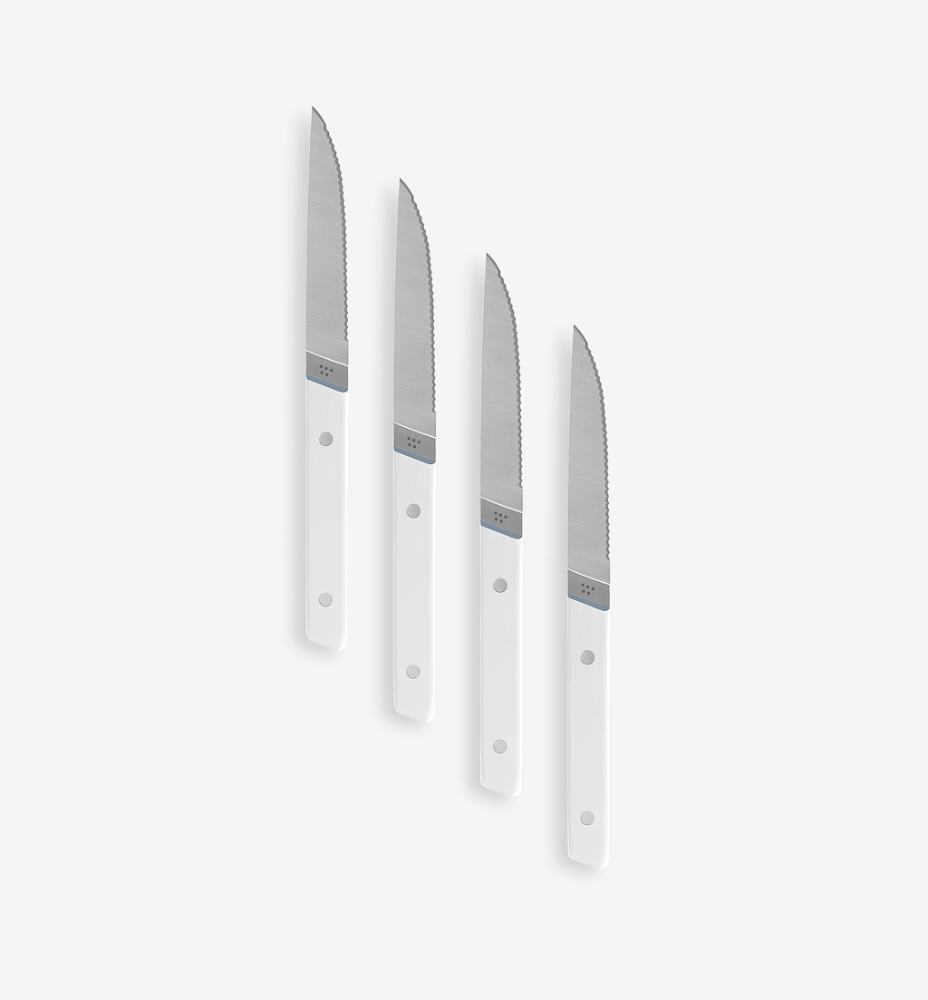 Set of 4 steak knives with serrated blades and white handles