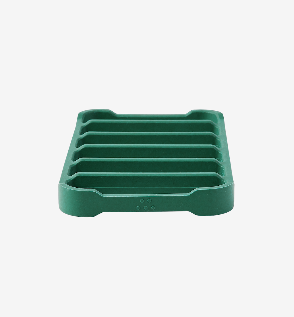 Green silicone soap dish with ribbed drainage design