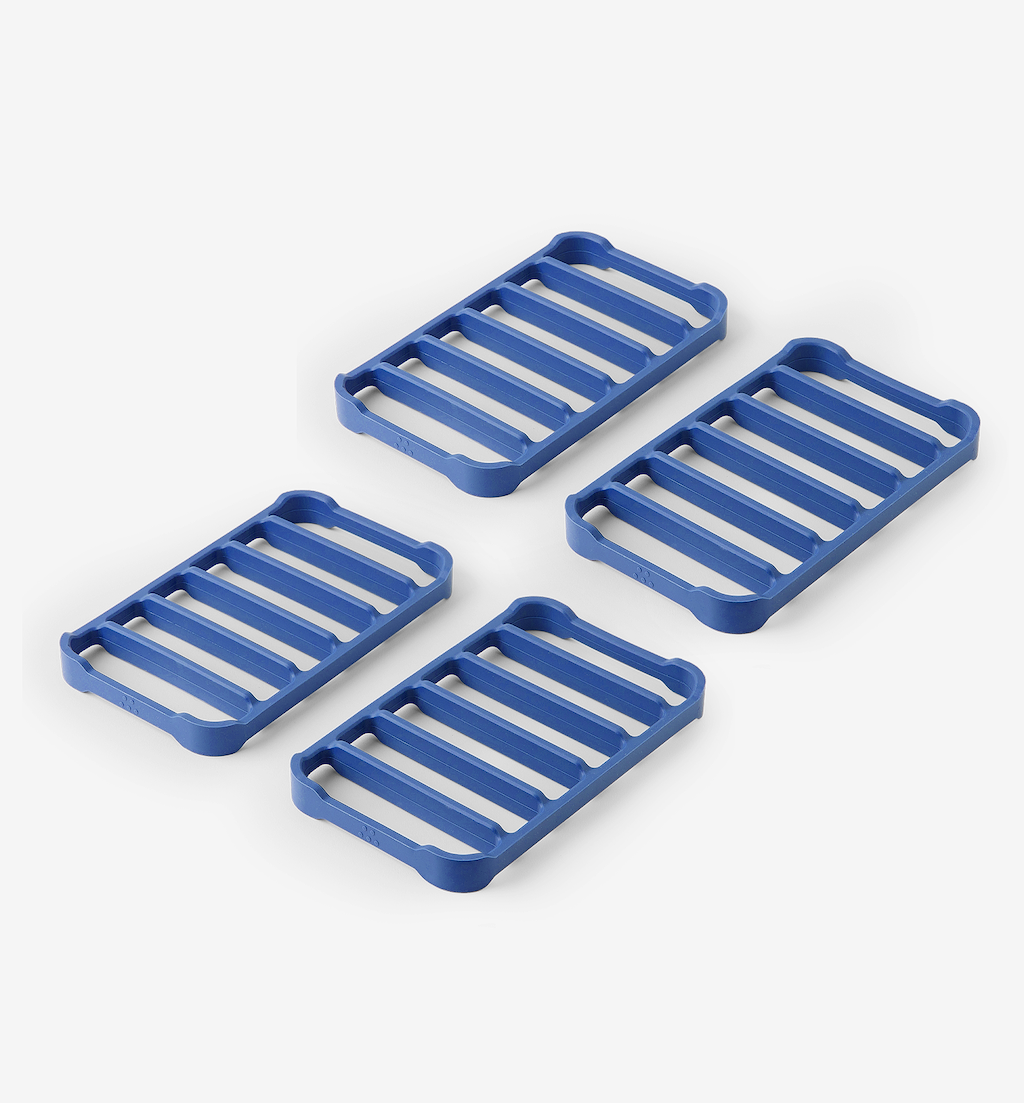 Set of 4 blue silicone trivets with slatted grid design for heat protection