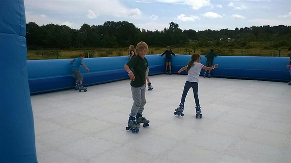 children roller skating at a temporary