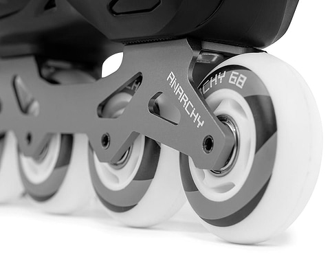The Anarchy Unity Adjustable Inline Skates feature white tires, an aluminum frame, and a sleek modern design, combining style and functionality in black.
