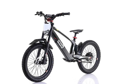 The Revvi 20" Kids Electric Balance Bike - Black features thick off-road rubber air-filled tires, a sturdy frame, front suspension fork, rear coil shock absorber, and a branded front plate. Its sporty design is ideal for trail riding.