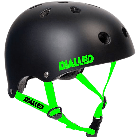 The Dialled Protection Adjustable Skate/Scooter Helmet in black with vibrant green straps and the Dialled brand logo features cooling air vents and an adjustable chin strap, ensuring both safety and comfort. Its robust ABS shell makes it perfect for activities requiring head protection.