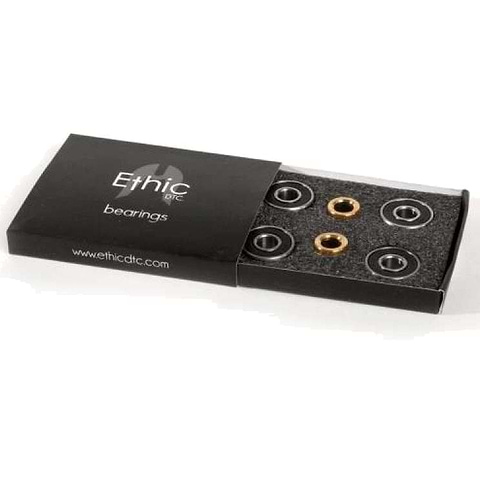 A black box marked "Ethic" holds four cylindrical ABEC 9 bearings, perfect for upgrading your scooter. The foam insert showcases the bearings, available in a stylish mix of black and gold to boost both performance and aesthetics. The box features the website "www.ethicdtc.com.