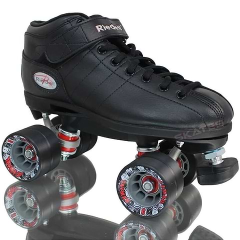 The Riedell R3 Roller Derby Quad Skates in black feature a sleek low-top boot design, complete with PowerDyne Thrust Nylon Plates. They come with four Radar Cayman wheels adorned with red and gray patterns and a front brake stopper, elegantly displayed on a reflective surface.