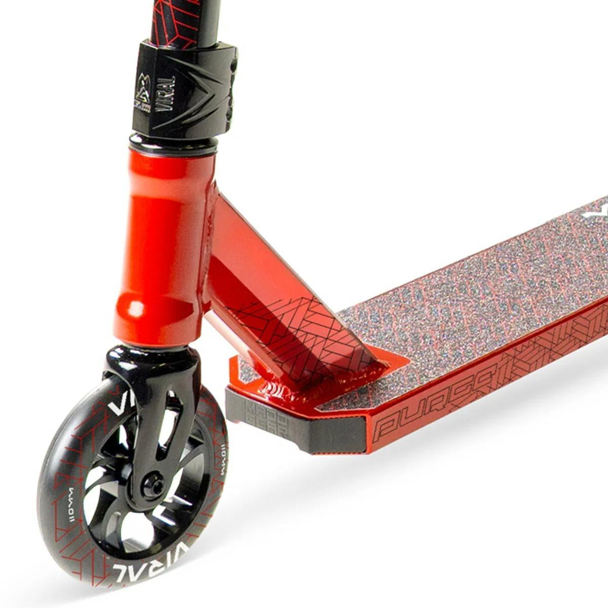 Close-up of the Madd Gear Viral Purge Complete Stunt Scooter - Cherry, highlighting its front wheel, fork, and griptape deck with geometric patterns and “PURGE” branding—ideal for bold skatepark sessions.