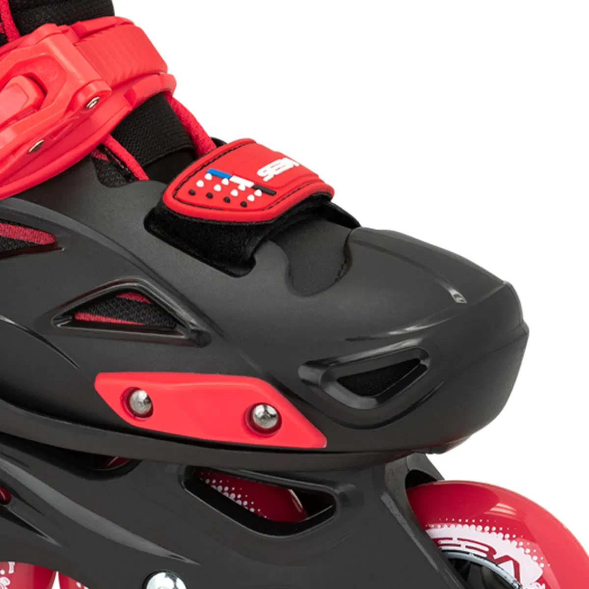 Close-up of Seba STJ Junior Adjustable Inline Skates in black and red, highlighting the front section with plastic details, fastening straps, and part of the front wheel.