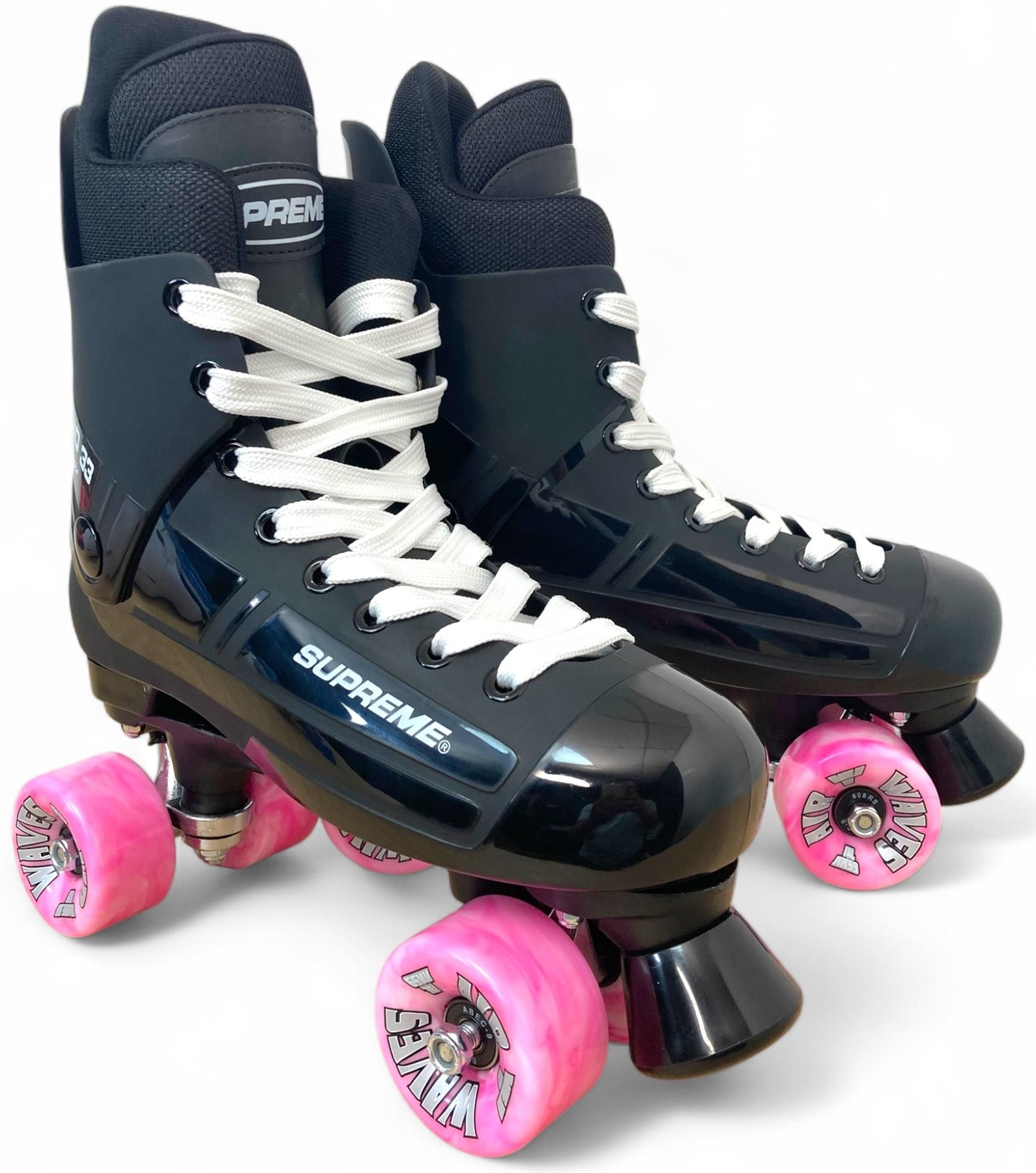 A pair of Supreme Turbo 33 Nylon Quad Roller Skates in black with pink swirl wheels and white laces, displayed on a white background.