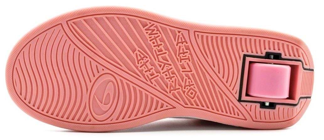 The image displays the pink sole of the Breezy Rollers Classic Shoes by Breezy Rollers, featuring a patented wheel system in the heel and embossed patterns, showcasing innovation in these stylish rolling shoes.