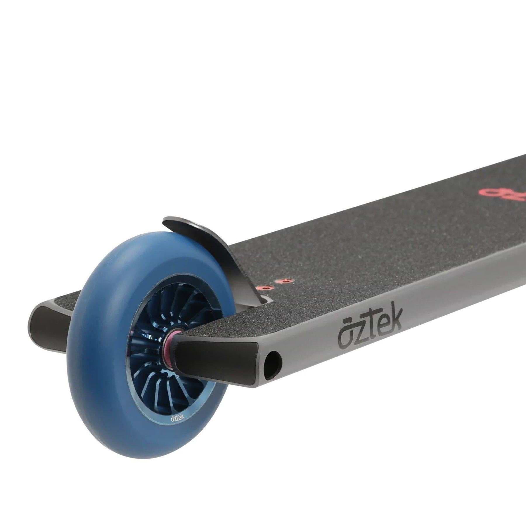 Close-up of the rear end of the Aztek Siren Complete Street Stunt Scooter in grey, showing a blue wheel, metal brake, textured grip deck, and "aztek" branding on the side.