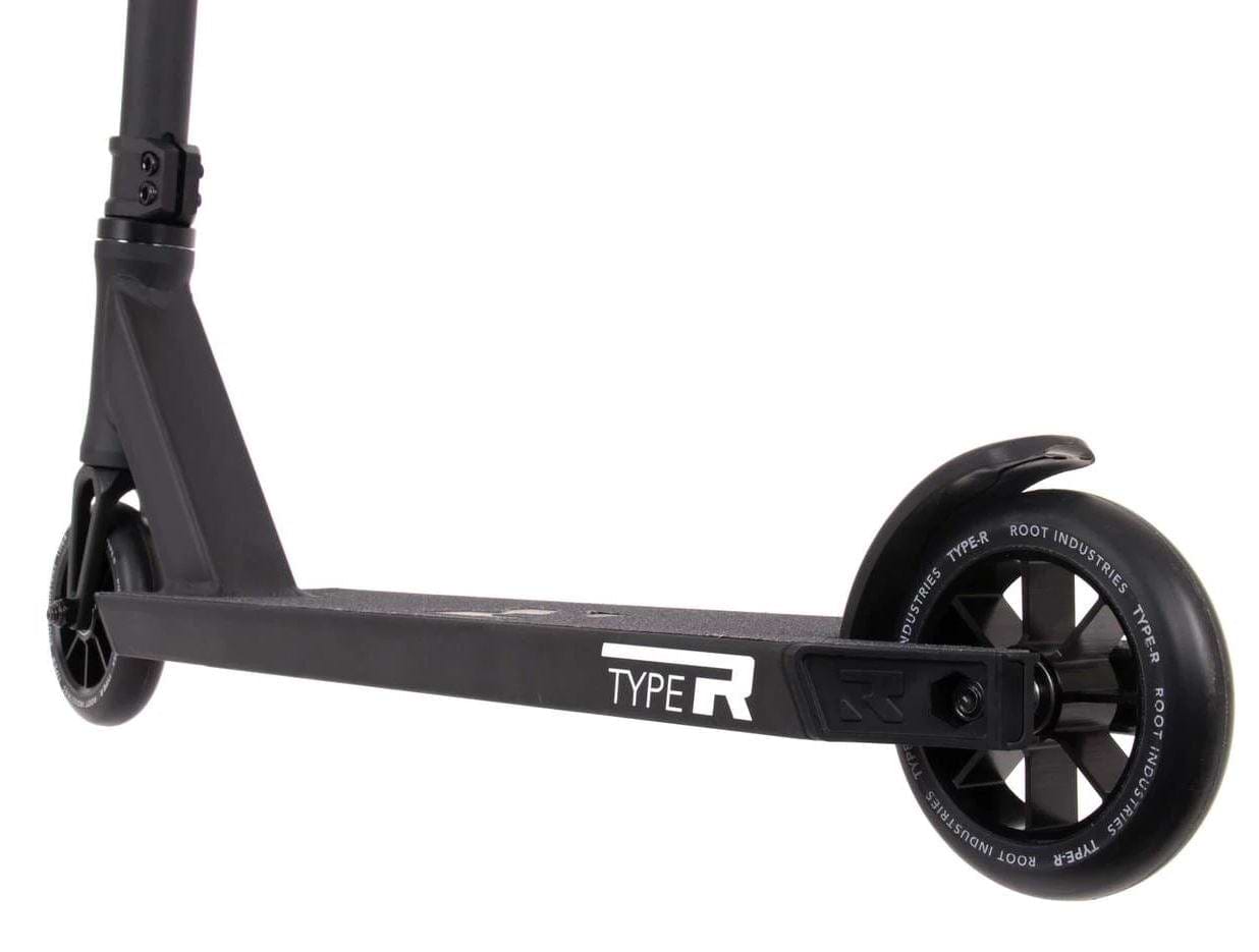 Close-up of the Root Industries Type R Complete Stunt Scooter in black, showcasing its deck and wheels. The deck prominently displays the "TYPE R" text. A fender is positioned above the rear wheel, complementing the scooter's sleek and modern design with its emphasis on clean lines and robust appearance.
