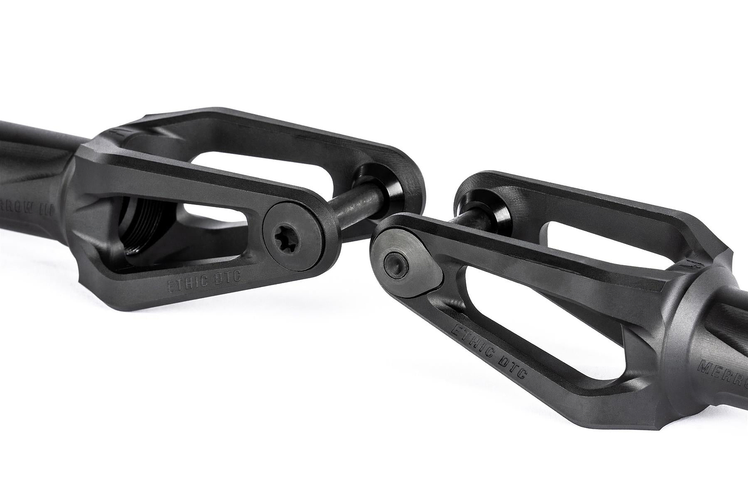 Close-up of two Ethic DTC Merrow V3 8/12STD HIC Stunt Scooter Forks in black, aligned facing each other with bolts, against a white background.