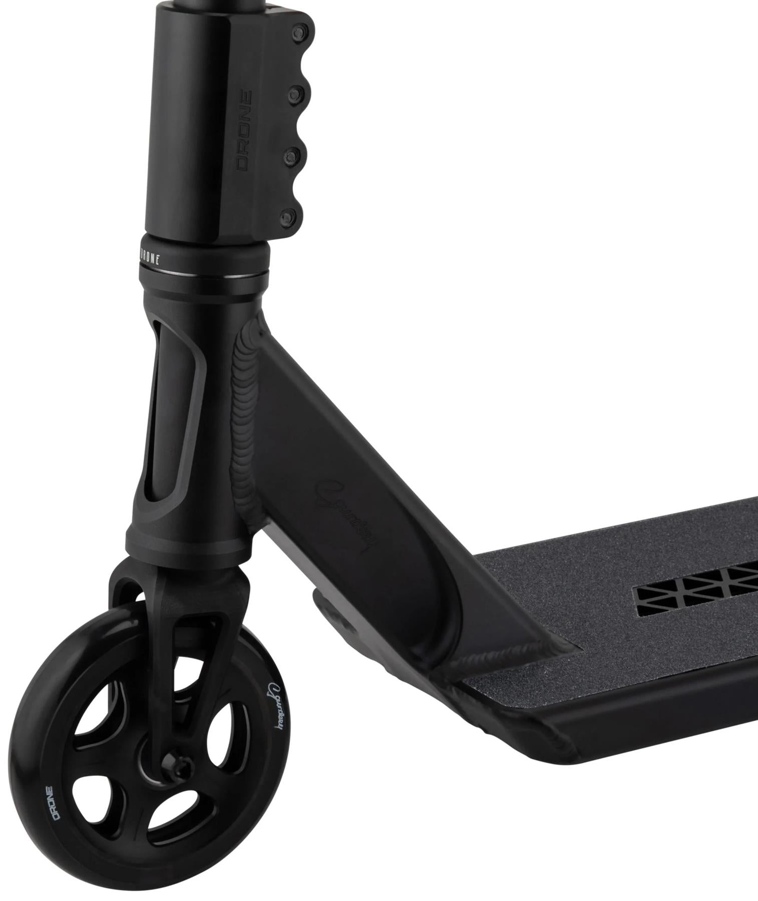 Close-up of the Drone Nexus Kai Saunders 'Saundezy' Signature Stunt Scooter front, highlighting the wheel, fork, clamp, and grippy deck surface.