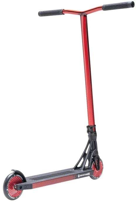 The Root Industries Invictus V3 Complete Stunt Scooter - Burnt Red features a bold red and black design, T-shaped handlebar, sturdy solid deck, and spoked Honeycore wheels with red accents.